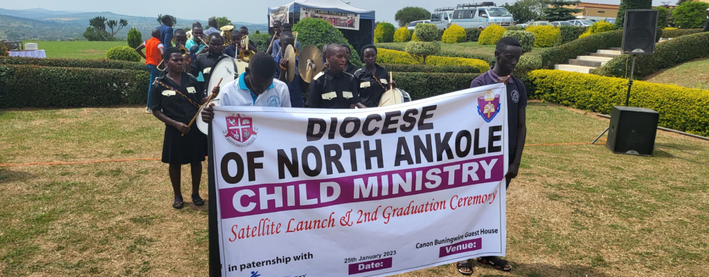 North Ankole Compassion students holding a banner delineating the Diocese of North Ankole children’s Ministry.